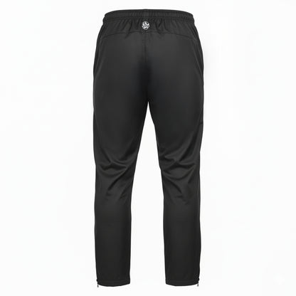 Rückseite einer schwarzen, schmal geschnittenen Trainingshose mit elastischem Bund und kleinem Força-Logo mittig oberhalb des Gesäßbereichs; Beinabschlüsse mit Reißverschlüssen.